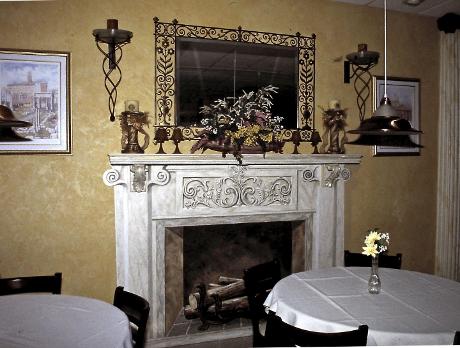 Trompe l' oeil fireplace painted in a restaurant by Mural Mural On The Wall, Inc.